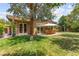 Expansive backyard features mature trees, patio seating, and lush green lawn at 6810 Silver Crescent St, Las Vegas, NV 89148