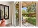 Serene backyard featuring lush green lawn, mature trees, and a cozy seating area with shaded patio at 6810 Silver Crescent St, Las Vegas, NV 89148