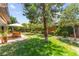 A spacious backyard features well-maintained lawn, beautiful landscaping, and an outdoor dining area at 6810 Silver Crescent St, Las Vegas, NV 89148