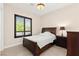 Bedroom features a decorative ceiling light, plantation shutters, and dark furniture at 6810 Silver Crescent St, Las Vegas, NV 89148