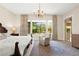 Bright bedroom featuring a large window overlooking the backyard at 6810 Silver Crescent St, Las Vegas, NV 89148