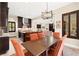 Open concept kitchen and dining room with dark wood cabinets and table at 6810 Silver Crescent St, Las Vegas, NV 89148