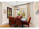 Inviting dining room with modern chandelier and sliding glass doors opening to the beautiful outdoor space at 6810 Silver Crescent St, Las Vegas, NV 89148