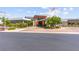 Modern building exterior with an American flag, landscaping, and circular driveway at 6810 Silver Crescent St, Las Vegas, NV 89148