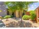Charming front yard with gravel, walkway, green plants, and mature tree at 6810 Silver Crescent St, Las Vegas, NV 89148