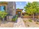 Charming home exterior featuring stone accents, landscaped yard and address number display at 6810 Silver Crescent St, Las Vegas, NV 89148