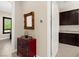 A bright hallway features a mirrored accent piece, adding a touch of elegance to the interior at 6810 Silver Crescent St, Las Vegas, NV 89148