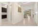 Hallway featuring tile floors, art, and a peek into the living room at 6810 Silver Crescent St, Las Vegas, NV 89148