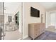 Hallway featuring a dresser, TV, mirror, and rug at 6810 Silver Crescent St, Las Vegas, NV 89148