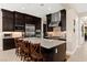 Modern kitchen with stainless steel appliances, center island and dark wood cabinetry at 6810 Silver Crescent St, Las Vegas, NV 89148