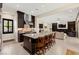 Open kitchen featuring an island with bar seating, modern appliances, and dark cabinetry at 6810 Silver Crescent St, Las Vegas, NV 89148