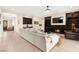 Cozy living room includes a fireplace, large sofa, and built-in dark wood shelving at 6810 Silver Crescent St, Las Vegas, NV 89148