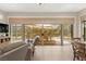 Bright sunroom with tile flooring, comfortable seating, and scenic backyard views at 6810 Silver Crescent St, Las Vegas, NV 89148
