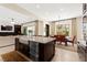 Bright open floorplan featuring a kitchen island, a dining room table, and living room sofa at 6810 Silver Crescent St, Las Vegas, NV 89148