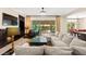 Elegant living room with fireplace, dark wood built-ins, and a comfortable, oversized couch at 6810 Silver Crescent St, Las Vegas, NV 89148