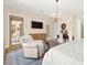 Inviting bedroom with sitting area, decorative rug, chandelier, and access to a private outdoor space at 6810 Silver Crescent St, Las Vegas, NV 89148
