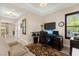 Well-lit home office space with neutral walls, built-in shelving, and comfortable seating at 6810 Silver Crescent St, Las Vegas, NV 89148