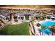 An aerial view shows a resort-style community pool, clubhouse, and manicured lawns with palm trees at 6810 Silver Crescent St, Las Vegas, NV 89148