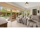 Bright sunroom with tile flooring, comfortable seating, and views of the backyard at 6810 Silver Crescent St, Las Vegas, NV 89148
