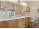 Bathroom features double sinks, vanity, and framed mirrors at 7817 Homing Pigeon St, North Las Vegas, NV 89084