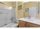 Bathroom with shower-tub combination, neutral walls, and wood-grain vanity at 7817 Homing Pigeon St, North Las Vegas, NV 89084