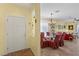 Inviting dining area with a glass-top table, elegant chandelier, and access to the living room at 7817 Homing Pigeon St, North Las Vegas, NV 89084