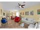 Spacious living room showcasing tile flooring, a ceiling fan, and comfortable seating at 7817 Homing Pigeon St, North Las Vegas, NV 89084