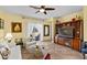 Cozy living room with tile flooring, a ceiling fan, and built-in shelving at 7817 Homing Pigeon St, North Las Vegas, NV 89084