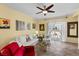 Bright living room with tile floors, neutral paint, backyard views, and comfortable seating at 7817 Homing Pigeon St, North Las Vegas, NV 89084