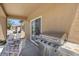 Covered patio with stainless grill, seating area, and sliding glass door at 7817 Homing Pigeon St, North Las Vegas, NV 89084