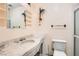 Bathroom featuring a marble countertop vanity, decorative sconces, and a glass-enclosed shower at 7898 Wishing Well Rd, Las Vegas, NV 89123