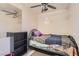 Small bedroom with white-tiled walls, a ceiling fan, and carpeted floors at 7898 Wishing Well Rd, Las Vegas, NV 89123