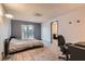 Bedroom featuring neutral walls, carpeted floors, and natural light through a sliding glass door at 7898 Wishing Well Rd, Las Vegas, NV 89123