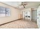 Neutral bedroom featuring a ceiling fan, mirrored closet doors, and ample natural light at 7898 Wishing Well Rd, Las Vegas, NV 89123