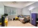 Bedroom featuring blue walls, wood floors, a window, and a purple storage locker at 7898 Wishing Well Rd, Las Vegas, NV 89123