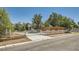 Charming single-story home with a gated driveway entrance, lush landscaping at 7898 Wishing Well Rd, Las Vegas, NV 89123