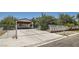 Charming single-story home with a large carport and gated driveway entrance, lush landscaping at 7898 Wishing Well Rd, Las Vegas, NV 89123