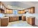 Traditional kitchen with light wood cabinetry, tile flooring, and a window over the sink at 7898 Wishing Well Rd, Las Vegas, NV 89123