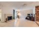 Spacious living room with light wood floors, a brick fireplace, and plenty of natural light at 7898 Wishing Well Rd, Las Vegas, NV 89123