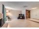 Bright and open living room featuring a fireplace, brick accent wall, and adjacent dining area at 7898 Wishing Well Rd, Las Vegas, NV 89123