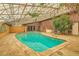 Enclosed pool area with ample space and glass ceiling providing natural light for swimming year-round at 7898 Wishing Well Rd, Las Vegas, NV 89123