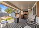 Inviting backyard with covered patio, outdoor dining area, built in grill and an artificial lawn at 8509 Lansdale Rd, Las Vegas, NV 89123