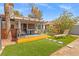Exterior view of a covered patio and artificial lawn with an extended backyard space at 8509 Lansdale Rd, Las Vegas, NV 89123