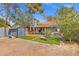 Beautiful view of the backyard featuring a patio, artificial grass, and trees surrounding the property at 8509 Lansdale Rd, Las Vegas, NV 89123