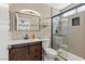 Modern bathroom with barn wood vanity, glass-enclosed shower, and neutral color palette at 8509 Lansdale Rd, Las Vegas, NV 89123