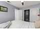 Cozy bedroom features a ceiling fan and an organized closet with shelves and drawers at 8509 Lansdale Rd, Las Vegas, NV 89123