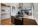Modern kitchen featuring stainless steel range and hood, quartz countertops, and wood cabinets at 8509 Lansdale Rd, Las Vegas, NV 89123