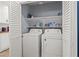 Functional laundry area features a side by side washer and dryer and shelving for storage at 8509 Lansdale Rd, Las Vegas, NV 89123