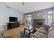 Cozy living room with gray sofa, fireplace, sliding doors to outdoor patio at 8509 Lansdale Rd, Las Vegas, NV 89123