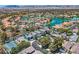 Beautiful aerial view of a lakeside community and houses with pools and tennis courts at 8713 Nautical Bay Ln, Las Vegas, NV 89117